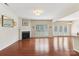 Large living room featuring hardwood floors, fireplace, and french doors at 9391 Leyton Dr, Harrisburg, NC 28075