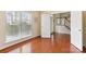 Light-filled living room featuring hardwood floors, large windows, and neutral paint at 9391 Leyton Dr, Harrisburg, NC 28075