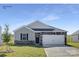 Charming single-Gathering home with stone accents, a well-manicured lawn, and a two-car garage at 112 Parker Claire Ln, Kings Mountain, NC 28086