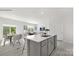 A modern kitchen features a large center island with an undermount sink and seating for three at 112 Parker Claire Ln, Kings Mountain, NC 28086