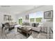 Sunlit living area featuring neutral decor, a comfortable sofa, and views of the green landscape at 112 Parker Claire Ln, Kings Mountain, NC 28086