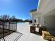 View from the side of community pool and poolhouse with stone columns, concrete deck, and wrought iron fence at 112 Parker Claire Ln, Kings Mountain, NC 28086