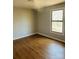 A serene bedroom with hardwood floors and a sunlit window, creating a peaceful ambiance at 1151 Bowling Green Dr, Clover, SC 29710