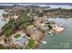 Aerial shot over neighborhood showcasing waterfront homes with well-maintained lawns, private docks and mature trees at 116 Cottage Grove Ln, Mooresville, NC 28117