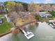 Bird's-eye view of a lakefront estate with a private dock, and mature trees creating a secluded setting at 116 Cottage Grove Ln, Mooresville, NC 28117