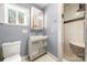 Bathroom with white toilet, modern sink, a shower, and a window with a view at 116 Cottage Grove Ln, Mooresville, NC 28117