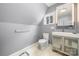 Bathroom with a toilet, sink and illuminated mirror, featuring a light gray wall paint and a window at 116 Cottage Grove Ln, Mooresville, NC 28117