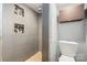 Modern bathroom featuring a tiled shower with built-in niches and a toilet at 116 Cottage Grove Ln, Mooresville, NC 28117