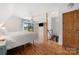 Bright bedroom with wood floors and access to a landing overlooking lake at 116 Cottage Grove Ln, Mooresville, NC 28117