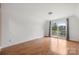 Bright bedroom with hardwood floors, natural light, and balcony overlooking lake at 116 Cottage Grove Ln, Mooresville, NC 28117