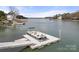 Close view of private boat dock, providing easy access to the tranquil lake waters surrounded by lush landscapes at 116 Cottage Grove Ln, Mooresville, NC 28117