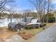 Aerial view showing the exterior of a beautiful home with mature landscaping near a lake at 116 Cottage Grove Ln, Mooresville, NC 28117