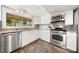 Kitchen featuring white cabinets, stainless appliances, and a view of the backyard at 116 Cottage Grove Ln, Mooresville, NC 28117