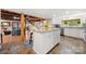 Open kitchen with island, white cabinets, stainless appliances, and a view of the living area at 116 Cottage Grove Ln, Mooresville, NC 28117