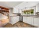 Kitchen featuring white cabinets, stainless appliances and sink looking out onto the backyard at 116 Cottage Grove Ln, Mooresville, NC 28117