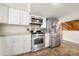 Kitchen featuring stainless steel appliances, white cabinets, and stone countertops at 116 Cottage Grove Ln, Mooresville, NC 28117