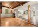 Open floor plan with a kitchen and living area featuring hardwood floors and exposed wood beams at 116 Cottage Grove Ln, Mooresville, NC 28117