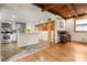 Open layout featuring a kitchen and a living area with wood floors and exposed beams at 116 Cottage Grove Ln, Mooresville, NC 28117