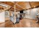 Open concept living room features wood floors, brick fireplace, ceiling fan, and access to kitchen at 116 Cottage Grove Ln, Mooresville, NC 28117