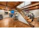 Staircase to living room features exposed wood beams, wood floors, and brick fireplace at 116 Cottage Grove Ln, Mooresville, NC 28117