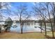 Beautiful lake view showcasing direct water access with the shoreline and numerous docks visible beyond the trees at 116 Cottage Grove Ln, Mooresville, NC 28117