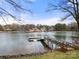 Scenic waterfront view featuring a private dock, and calm lake waters with other houses visible across the lake at 116 Cottage Grove Ln, Mooresville, NC 28117