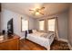 Bedroom with a bed, TV, hardwood floors, and ample natural light from three windows at 129 38Th St, Hickory, NC 28601