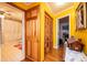 Hallway with yellow walls featuring closet space and access to bathroom and other rooms at 129 38Th St, Hickory, NC 28601