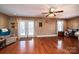 Open living room features wood floors, ceiling fan and a glass paneled door to the outside deck at 129 38Th St, Hickory, NC 28601