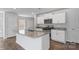 Modern kitchen featuring an island, stainless steel appliances, granite countertops, and white cabinetry at 1407 5Th Street Ne Dr, Hickory, NC 28601