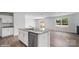 Modern kitchen featuring an island with a stainless steel dishwasher and an open layout to living area at 1407 5Th Street Ne Dr, Hickory, NC 28601