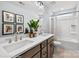 Modern bathroom with double sink vanity, decorative mirrors and artwork, and a shower-tub combo at 1440 Ardmore Dr # 343, Sherrills Ford, NC 28673