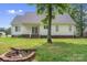 Back of house with fire pit and covered back porch at 145 Mcbride Dr, Rockwell, NC 28138
