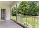 View from a covered back porch overlooking the spacious backyard with a storage shed at 145 Mcbride Dr, Rockwell, NC 28138