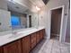 Bright bathroom featuring a dual sink vanity, a large mirror, and ceramic tile floors at 145 Mcbride Dr, Rockwell, NC 28138