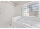 A bright white bathroom features a combination tub and shower with a textured glass window at 145 Mcbride Dr, Rockwell, NC 28138