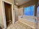 Bathroom with a tiled shower/tub and a window with blue tinted glass at 145 Mcbride Dr, Rockwell, NC 28138