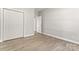 Bedroom highlighting wood-look flooring, white trim, and closet space for storage solutions at 145 Mcbride Dr, Rockwell, NC 28138