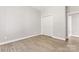 Neutral bedroom featuring wood-look floors, white trim, and closet space, offering a blank canvas for personalization at 145 Mcbride Dr, Rockwell, NC 28138