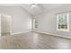 Light-filled bedroom with vaulted ceiling, two windows and modern wood-look floors at 145 Mcbride Dr, Rockwell, NC 28138