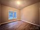 Bedroom with neutral walls, laminate flooring and a large window at 145 Mcbride Dr, Rockwell, NC 28138