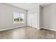 Bedroom with natural light, featuring a closet and wood-look flooring, offering a versatile living space at 145 Mcbride Dr, Rockwell, NC 28138