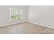 Bright bedroom with natural light, wood-look flooring, and neutral walls, providing a calming atmosphere at 145 Mcbride Dr, Rockwell, NC 28138