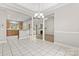 Bright dining area featuring tile flooring, decorative chandelier, and seamless flow into the kitchen and living spaces at 145 Mcbride Dr, Rockwell, NC 28138
