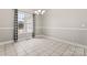 Bright dining room with tile flooring, a modern chandelier, and a large window at 145 Mcbride Dr, Rockwell, NC 28138