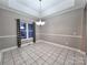 Dining room is bright with a decorative chandelier and decorative black and white curtains at 145 Mcbride Dr, Rockwell, NC 28138