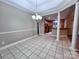 Dining area with elegant lighting fixture, columns, and tile flooring next to kitchen at 145 Mcbride Dr, Rockwell, NC 28138