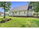 Back exterior view of the home with a well-maintained lawn and chain-link fence at 145 Mcbride Dr, Rockwell, NC 28138