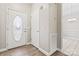 Bright foyer featuring wood-look flooring and neutral paint, leading to the dining area at 145 Mcbride Dr, Rockwell, NC 28138