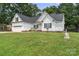 Charming one-story home with manicured lawn, white siding, and black shutters for a classic curb appeal at 145 Mcbride Dr, Rockwell, NC 28138